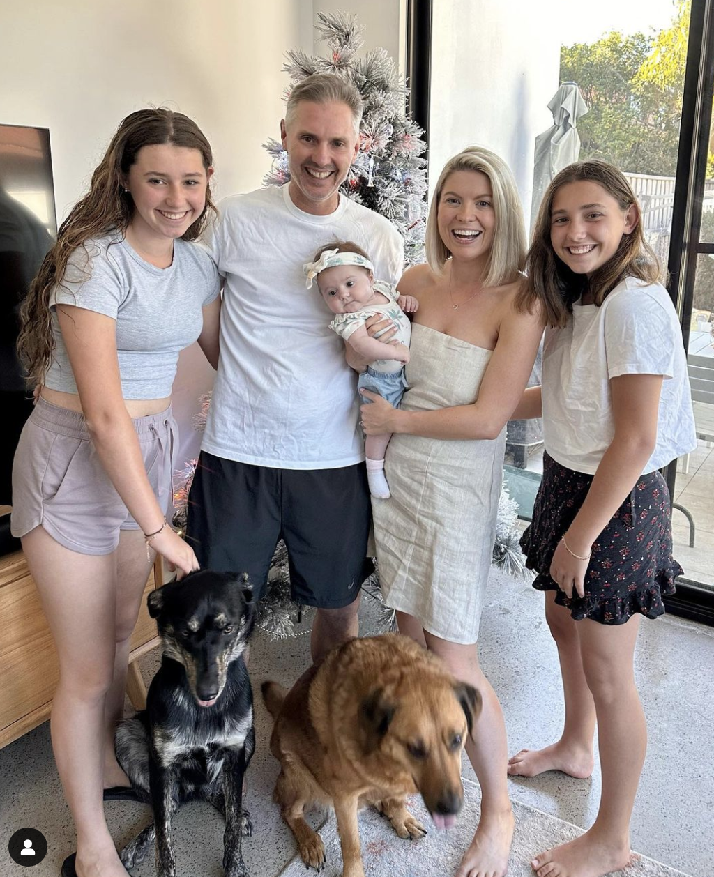 A happy family and their two dogs