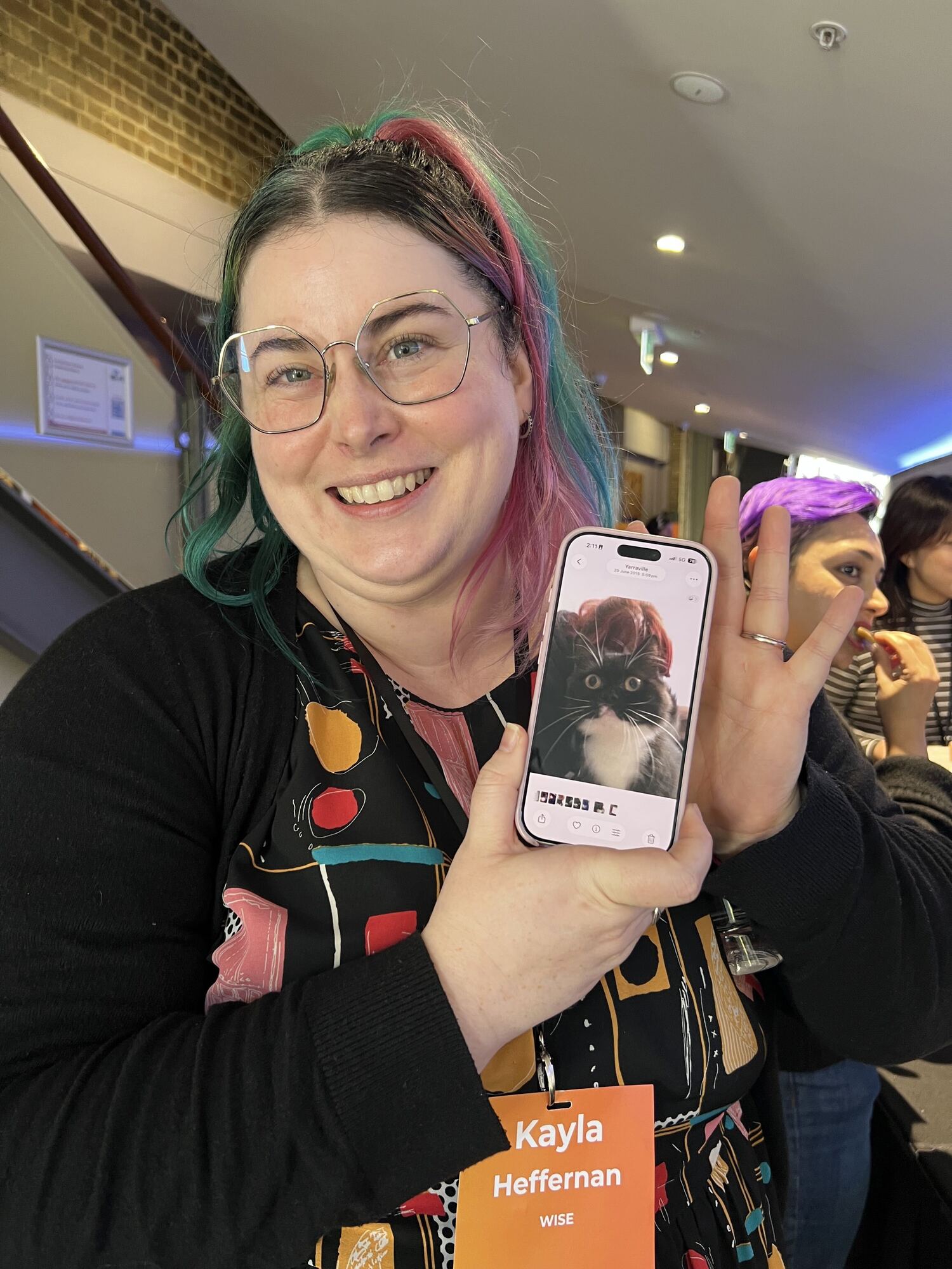 woman showing picture of cat on her phone